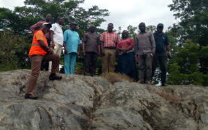 Ecobinder Team and NDPHC Representatives on the stone slab from which Ajaokuta derived its name located in Ajaokuta Native Town